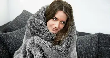 Chilly Woman On Couch Refuses To Leave Blanket, Makes Banana Chips Work As Dinner