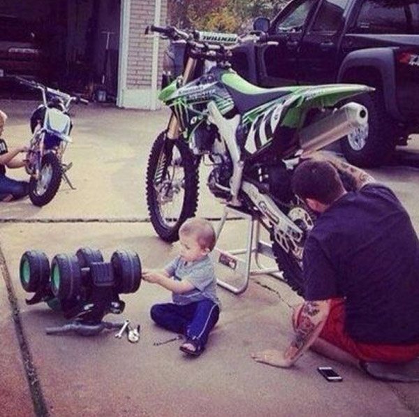 Dad Son Working On Bike